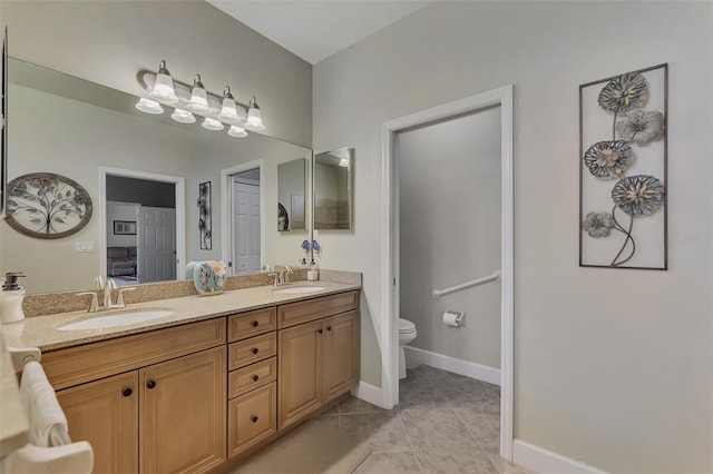 bathroom featuring tile patterned flooring, a sink, toilet, and double vanity