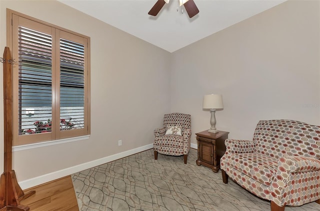 living area featuring ceiling fan and light hardwood / wood-style floors