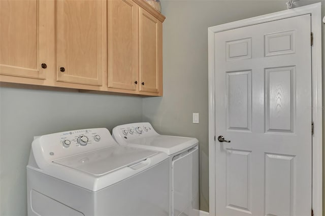 laundry room featuring cabinet space and separate washer and dryer