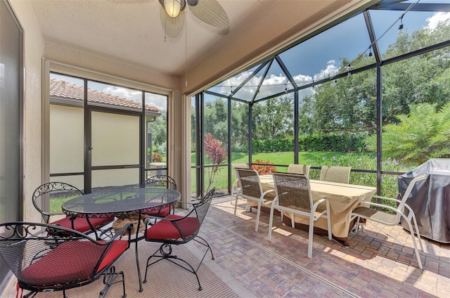 sunroom featuring ceiling fan