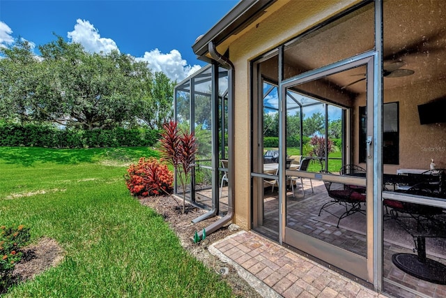 exterior space featuring stucco siding, a lawn, and a patio