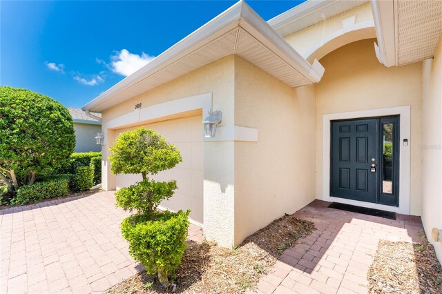 doorway to property with a garage