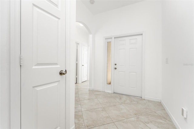 hall with light tile patterned floors