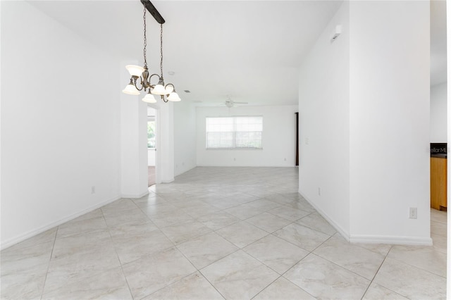 spare room featuring ceiling fan with notable chandelier