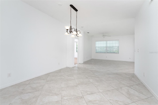 spare room with lofted ceiling and a chandelier