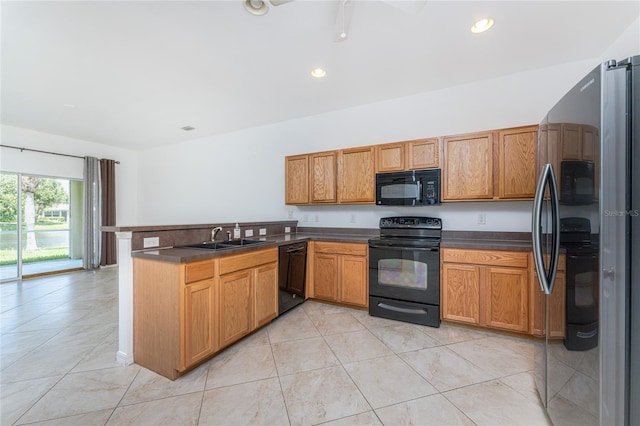 kitchen with sink, kitchen peninsula, and black appliances