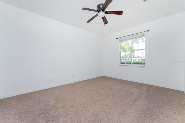 unfurnished room with ceiling fan and light carpet