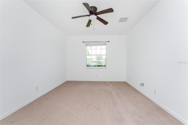 unfurnished room with light colored carpet and ceiling fan