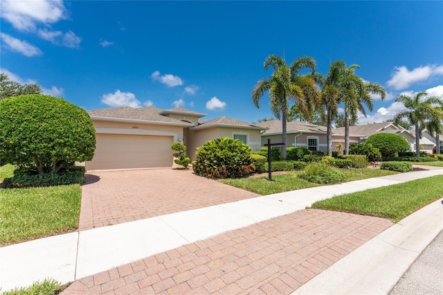 view of front of house with a garage and a front yard