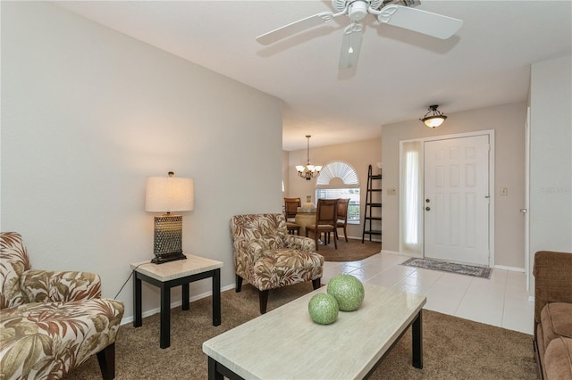 tiled living room featuring ceiling fan with notable chandelier