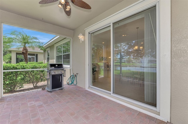 unfurnished sunroom with ceiling fan