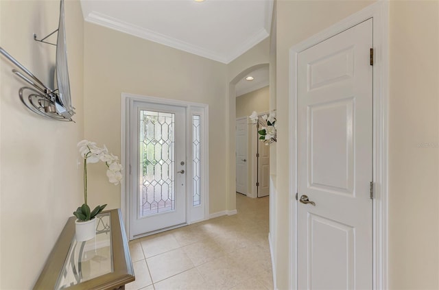 foyer featuring light tile patterned floors and ornamental molding