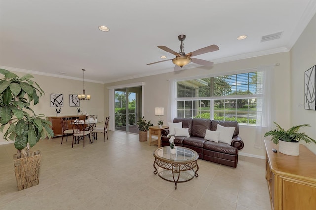 tiled living room featuring ornamental molding and ceiling fan with notable chandelier