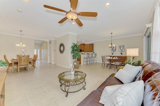 living room with light tile patterned floors, ceiling fan with notable chandelier, and ornamental molding