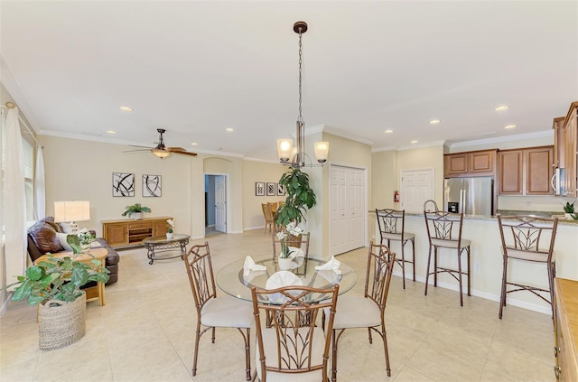 dining area with crown molding, light tile patterned floors, and ceiling fan