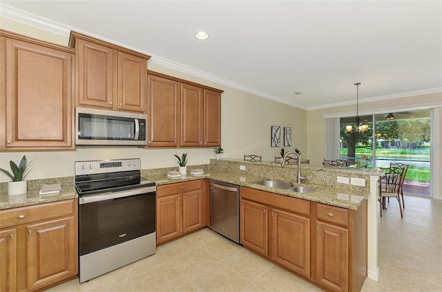 kitchen with pendant lighting, sink, stainless steel appliances, light stone counters, and kitchen peninsula