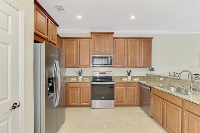 kitchen featuring sink, stainless steel appliances, ornamental molding, light stone countertops, and kitchen peninsula