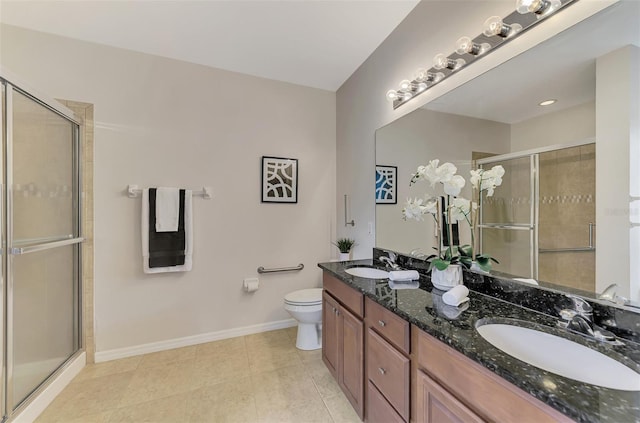 bathroom with an enclosed shower, vanity, tile patterned floors, and toilet