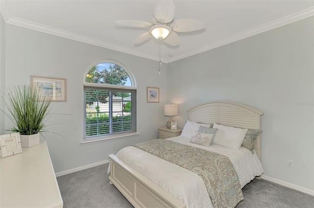 carpeted bedroom featuring ornamental molding and ceiling fan