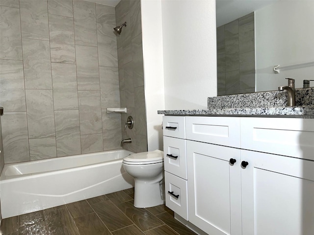 full bathroom with tiled shower / bath combo, vanity, and toilet