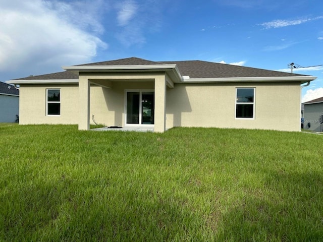 back of house featuring a yard