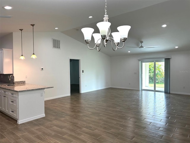 kitchen featuring ceiling fan with notable chandelier, sink, light stone countertops, and white cabinetry