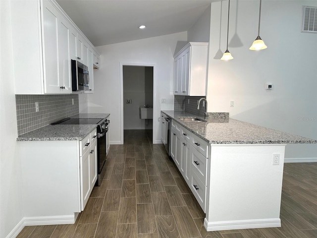 kitchen with stainless steel appliances, sink, white cabinets, light stone countertops, and pendant lighting