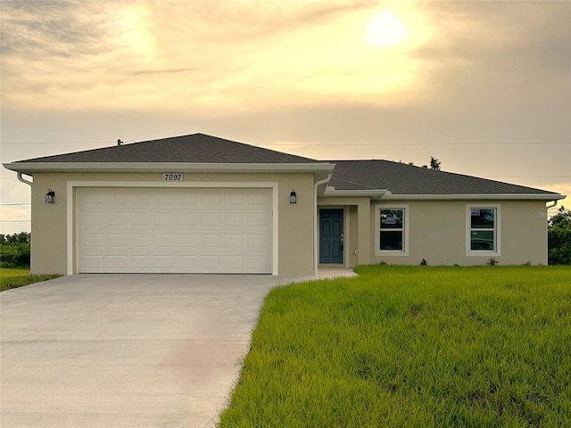 ranch-style house with a lawn and a garage