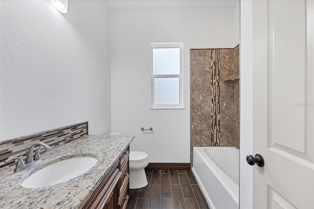 full bathroom featuring vanity, backsplash, bathtub / shower combination, and toilet