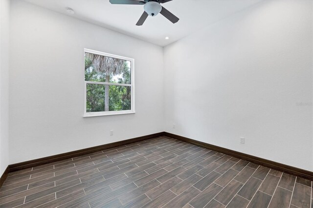 empty room with ceiling fan and dark hardwood / wood-style floors