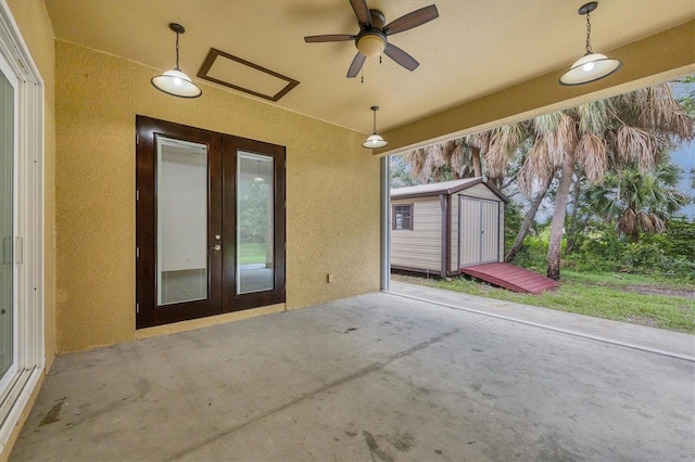 view of patio / terrace with french doors, a shed, and ceiling fan