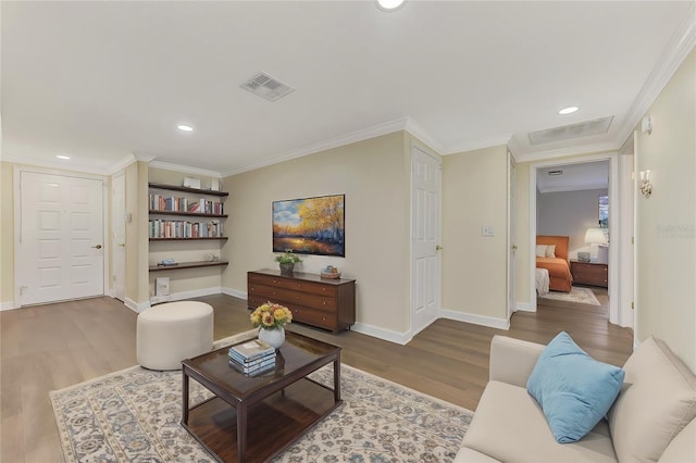 living room featuring hardwood / wood-style flooring and ornamental molding