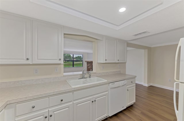 kitchen featuring white cabinetry, white appliances, sink, and hardwood / wood-style flooring