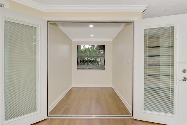 interior space featuring crown molding and light hardwood / wood-style floors