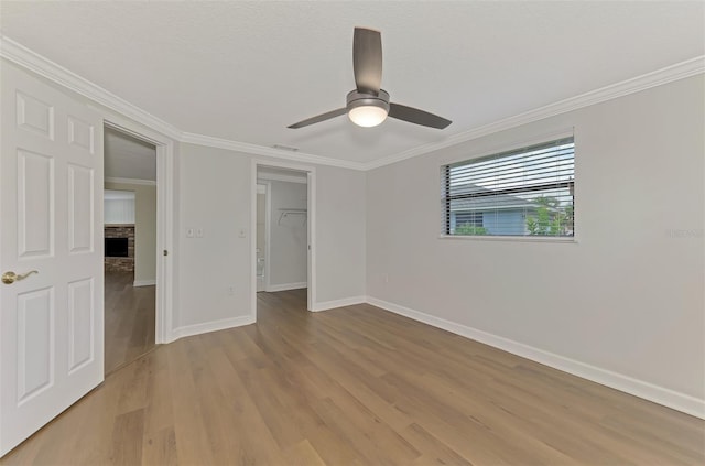 unfurnished bedroom featuring ceiling fan, ornamental molding, a closet, and light hardwood / wood-style flooring