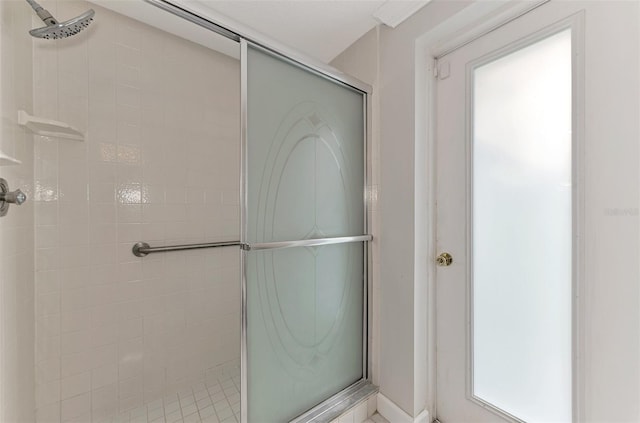 bathroom featuring a shower with shower door