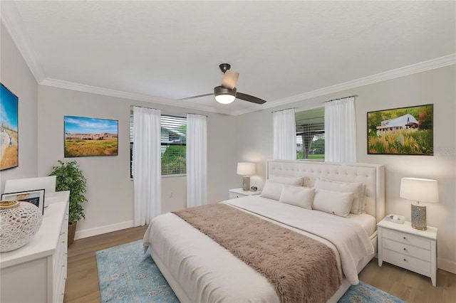 bedroom featuring ornamental molding, ceiling fan, and light hardwood / wood-style flooring