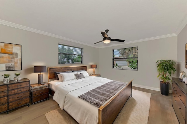 bedroom with ornamental molding, ceiling fan, and light hardwood / wood-style floors