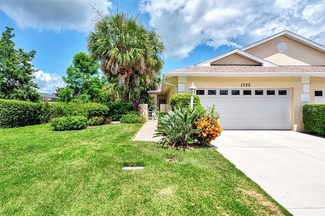 view of front of property featuring a garage and a front yard