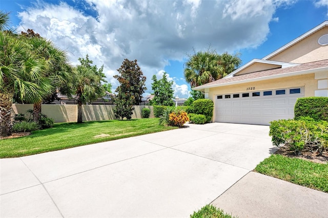 view of property exterior featuring a garage and a yard