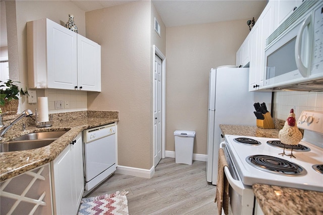 kitchen featuring light hardwood / wood-style floors, white cabinetry, tasteful backsplash, and white appliances