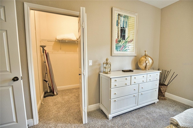 carpeted bedroom with a spacious closet and a closet