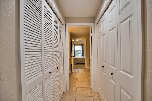 hall with light tile patterned floors