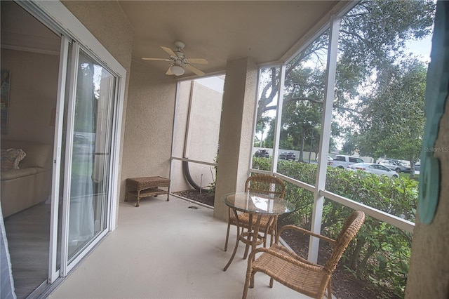 sunroom featuring ceiling fan