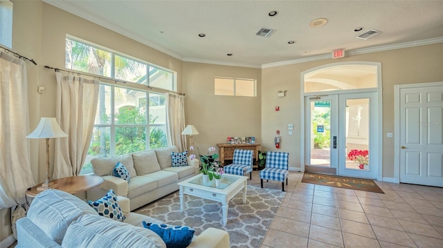 living room with french doors, light tile patterned floors, and ornamental molding