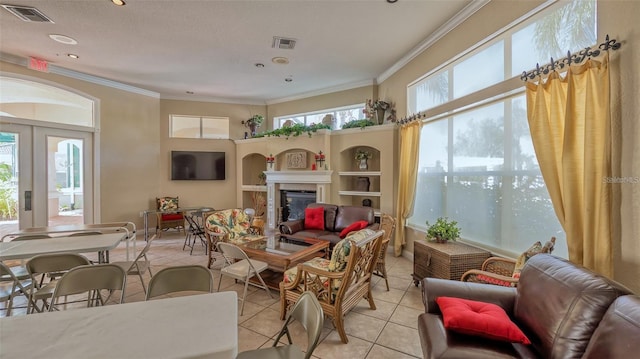 interior space with a healthy amount of sunlight, crown molding, and french doors