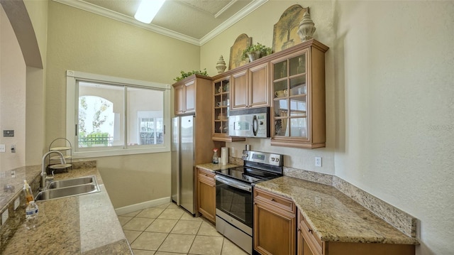 kitchen featuring crown molding, sink, light stone counters, appliances with stainless steel finishes, and light tile patterned floors