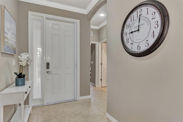 entrance foyer featuring light tile patterned flooring and ornamental molding