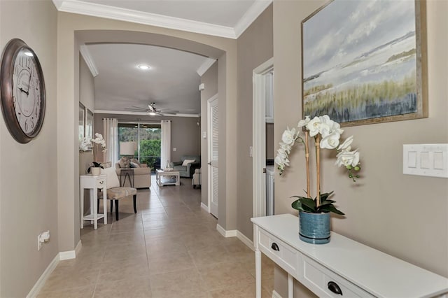 hall featuring ornamental molding and light tile patterned floors