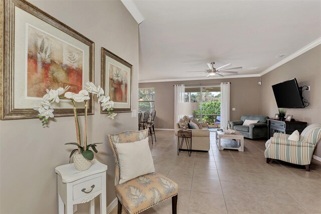 tiled living room featuring ornamental molding and ceiling fan